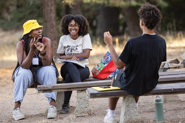 First Year Retreat Participants chatting at a picnic table