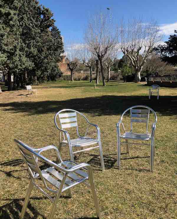3 empty chairs in the grass