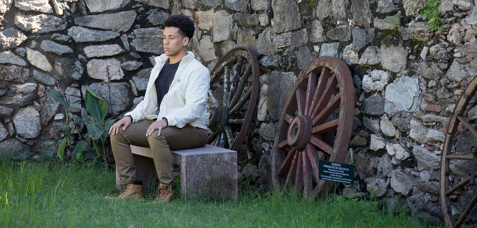 Student sitting outside in a meditation